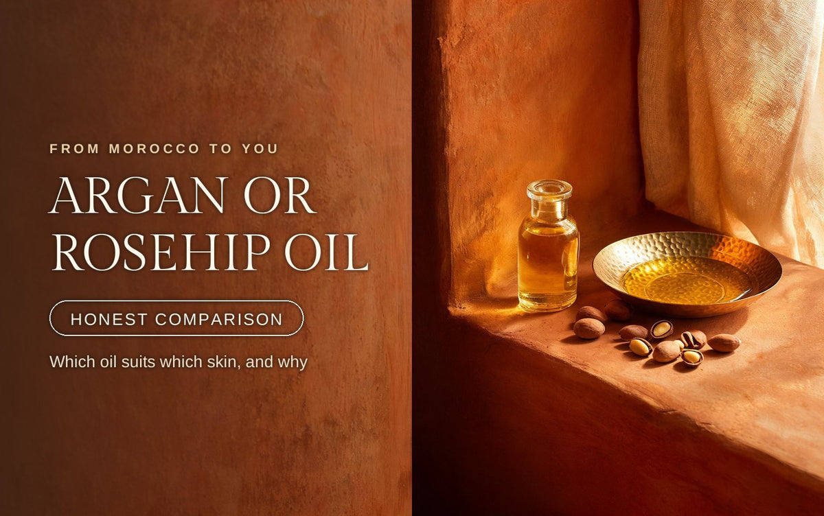 Two small amber glass bottles on warm clay, one pouring slow gold argan, one thin amber-red rosehip, dried rose hips scattered beside