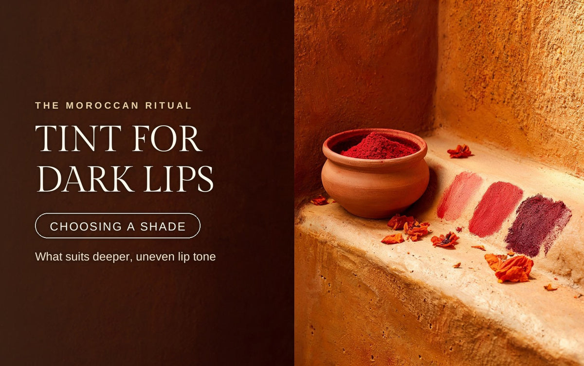 Terracotta aker fassi pot beside three graduated red-to-berry stain swatches brushed on a warm clay ledge