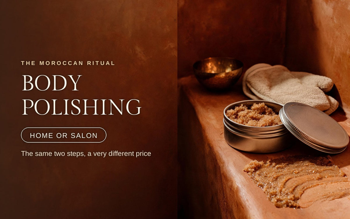 An open tin of oil-based body scrub with one swipe smeared across warm tadelakt, a linen mitt and brass bowl behind