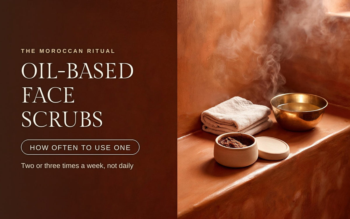 Ceramic pot of oil-based face scrub with its lid off beside folded towels and a steaming brass bowl