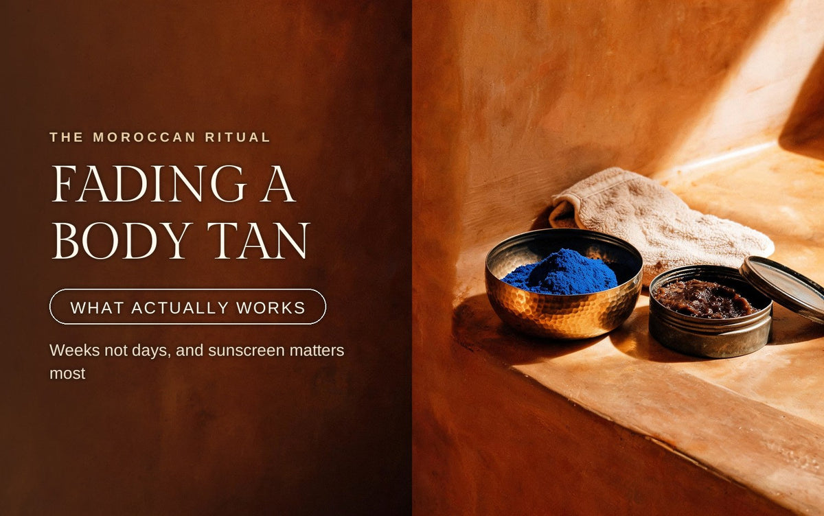 A brass bowl of ultramarine nila powder and an open tin of body scrub in hard afternoon light on warm tadelakt