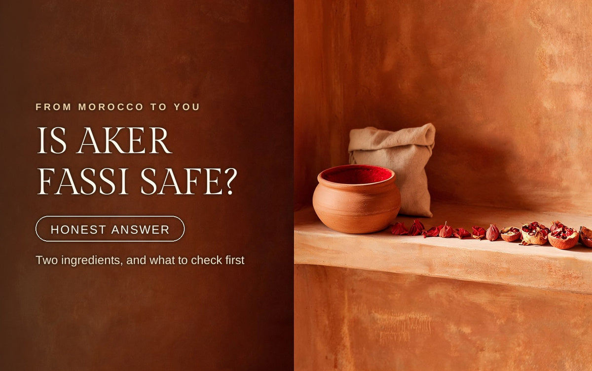 Terracotta aker fassi pot with dried poppy petals and pomegranate rind laid out beside it on a pale clay surface